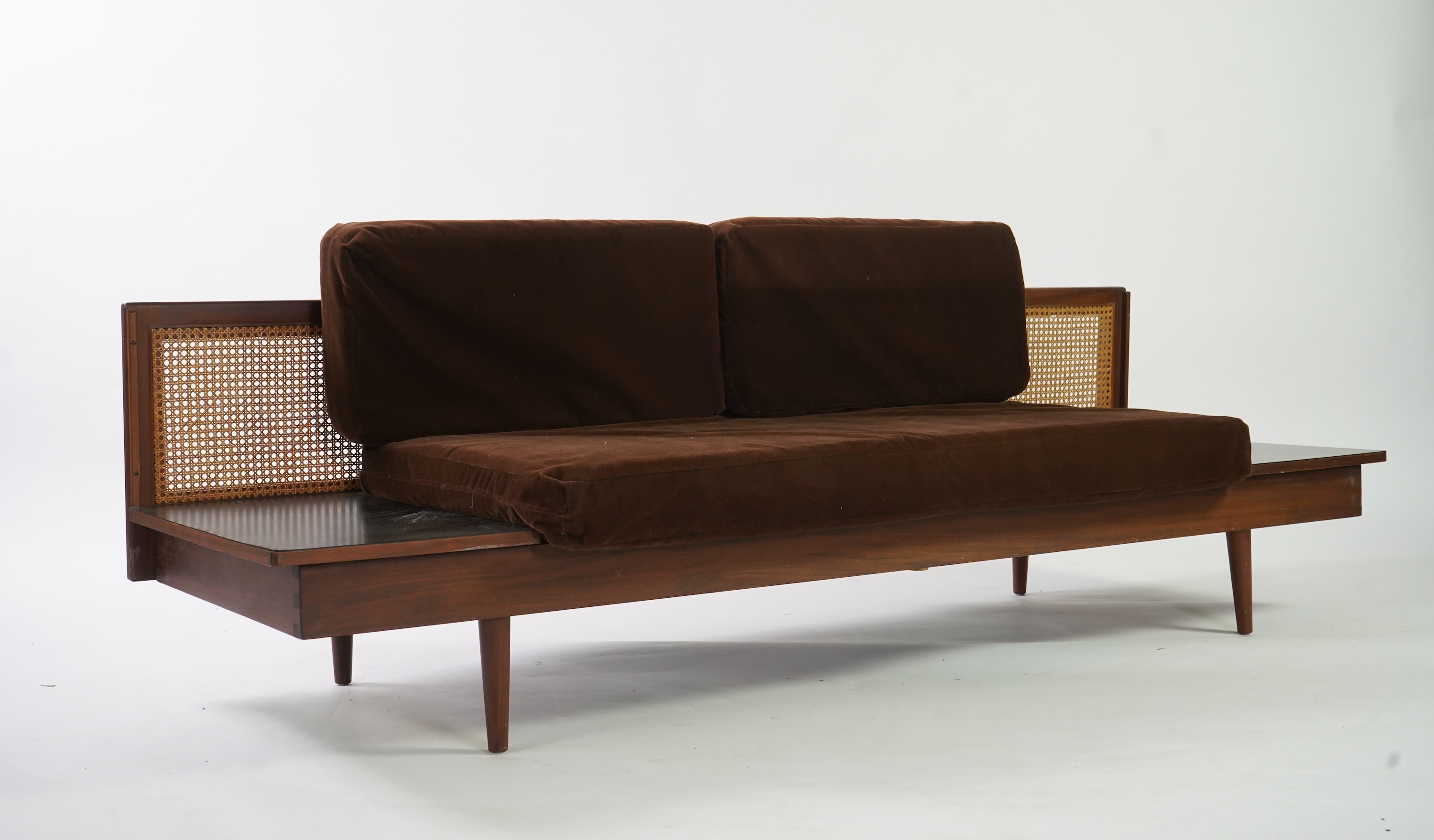 Dennis Young (British): A caned teak sofa/daybed